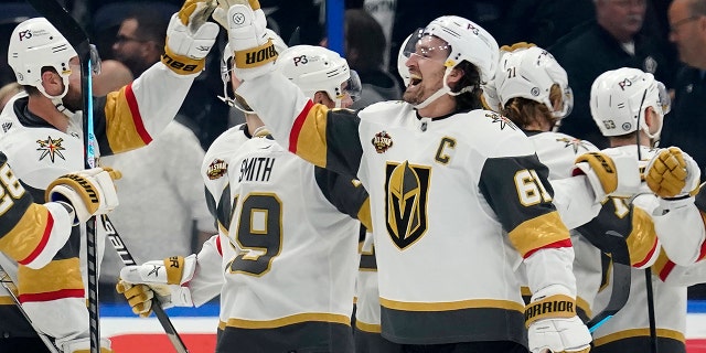 Vegas Golden Knights right wing Mark Stone (61) celebrates with teammates after scoring the game-winning goal during a shoot out against the Tampa Bay Lightning during an NHL hockey game Saturday, Jan. 29, 2022, in Tampa, Fla.