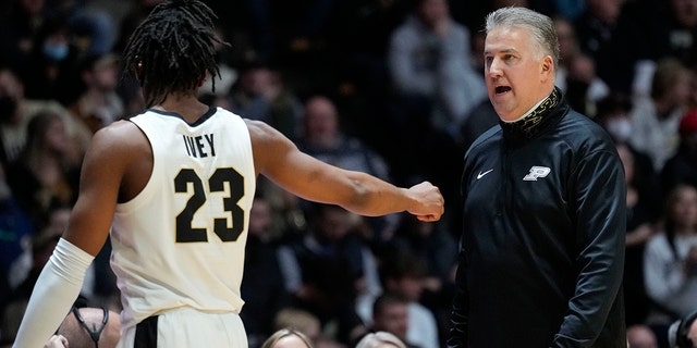 Purdue head coach Matt Painter, right, talks with his player Jaden Ivey while their team played Nebraska in the second half of an NCAA college basketball game in West Lafayette, Ind., Friday, Jan. 14, 2022. Purdue won 92-65.