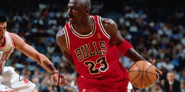 Michael Jordan #23 of the Chicago Bulls handles the ball during the game against the Miami Heat on Nov. 6, 1996 at the Miami Arena in Miami, Florida.