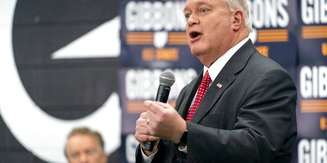 Mike Gibbons, a Republican Senate candidate for Ohio, speaks to supporters as Sen. Rand Paul, R-Ky., looks on during a campaign rally in Maineville, Ohio, Friday, Jan. 14, 2022.