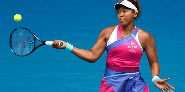Naomi Osaka of Japan plays a forehand return to Camila Osorio of Colombia during their first round match at the Australian Open tennis championships in Melbourne, Australia, Monday, Jan. 17, 2022.
