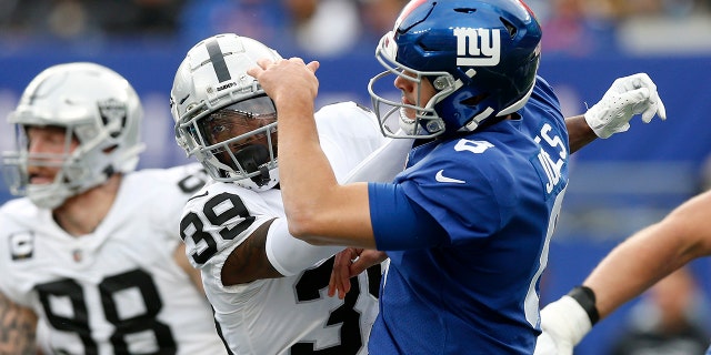 Nate Hobbs #39 of the Las Vegas Raiders in action against Daniel Jones #8 of the New York Giants at MetLife Stadium on November 07, 2021 in East Rutherford, New Jersey. The Giants defeated the Raiders 23-16.