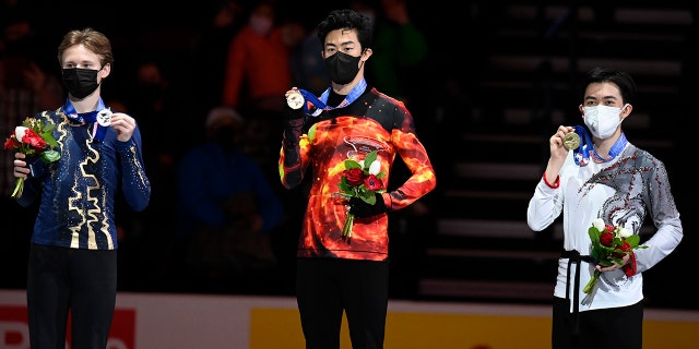 First place, Nathan Chen stands with second place, Ilia Malinin left, third place, Vincent Zhou during the medal ceremony for the men's free skate program during the U.S. Figure Skating Championships Sunday, Jan. 9, 2022, in Nashville, Tenn.