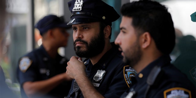 Officers from the New York City Police Department stand in Times Square in Manhattan, New York City, Aug. 19, 2021.