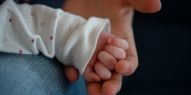 The hand of a two-week-old newborn lies in the hand of its mother in Stuttgart, Germany. In New Mexico, officials in Espa?ola are preparing to install a box where parents can safely surrender unwanted newborns, a report says.