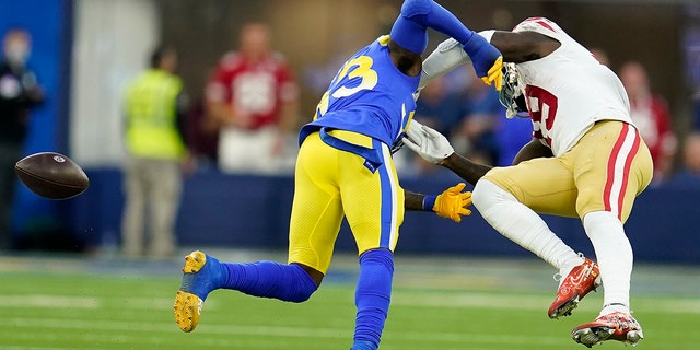 San Francisco 49ers' Deebo Samuel, right, cannot catch a pass after being hit by Los Angeles Rams' Nick Scott during the first half of the NFC Championship NFL football game Sunday, Jan. 30, 2022, in Inglewood, Calif.