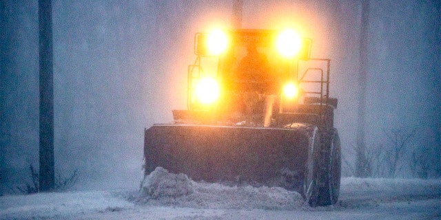 Plow in whiteout, East Squantum St. during the snowstorm in Quincy, MA on Jan. 29, 2022.