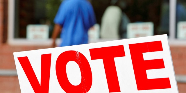 FILE PHOTO: Signs direct voters into a polling station during the 2020 presidential election in Durham, North Carolina, Nov. 3, 2020.   REUTERS/Jonathan Drake/File Photo