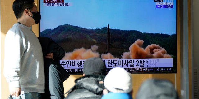 People are watching a TV screen showing a news program reporting on North Korea's missile launch with a file shot at a train station in Seoul. (AP Photo / Lee Jin-man)