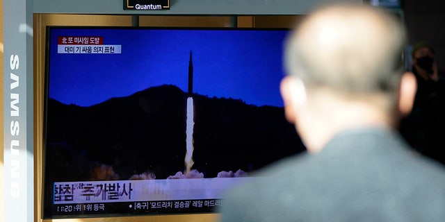 A man watches a TV screen showing a news program reporting about North Korea's missile launch with a file image, at a train station in Seoul, South Korea, Monday, Jan. 17, 2022. (AP Photo/Lee Jin-man)