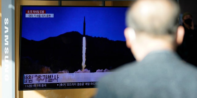 A man watches a television screen showing a news program reporting on North Korea's missile launch with a file image, at a train station in Seoul, South Korea, on Monday, January 17, 2022. (AP Photo / Lee Jin-man)