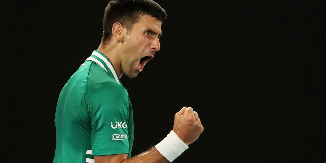 Serbia's Novak Djokovic celebrates winning the third set during his quarterfinal match against Germany's Alexander Zverev.