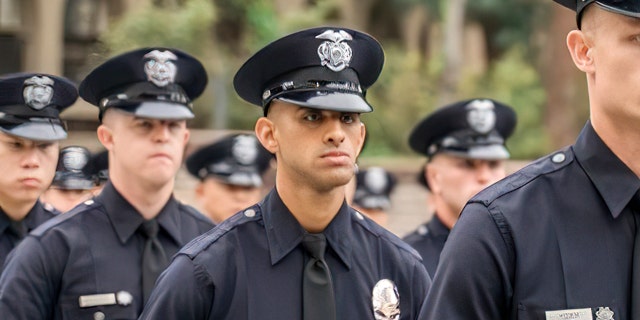 Los Angeles police officer Fernando Arroyos, center, was killed last month while house hunting with his girlfriend. Four people have been arrested in connection with the murder investigation and federal prosecutors will prosecute the case after Los Angeles County Sheriff Alex Villanueva bypassed the local district attorney.