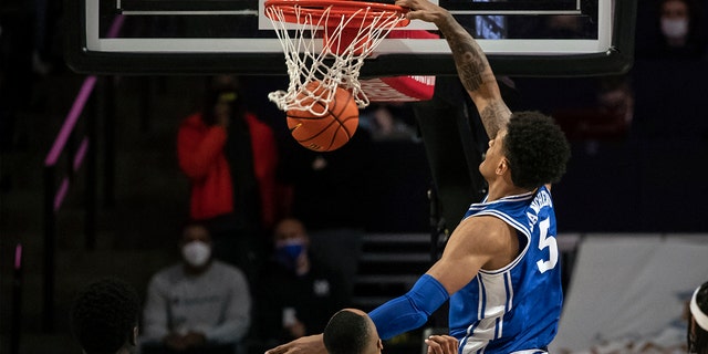 Duke forward Paolo Banchero (5) slam dunks over Wake Forest forward Dallas Walton (13) during the first half of an NCAA college basketball game on Wednesday, Jan. 12, 2022, in Winston-Salem, N.C.