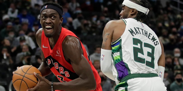 Toronto Raptors' Pascal Siakam drives to the basket against Milwaukee Bucks' Wesley Matthews (23) during the first half of an NBA basketball game Wednesday, Jan. 5, 2022, in Milwaukee.