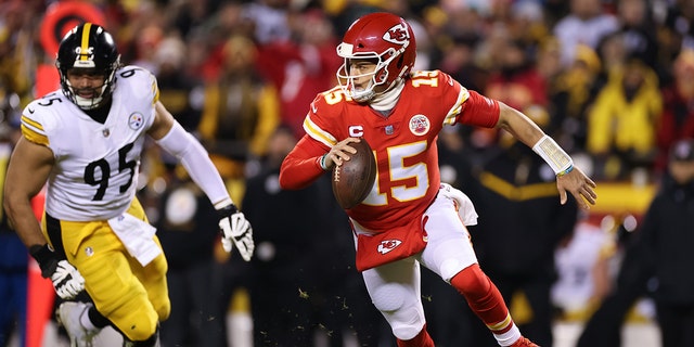Patrick Mahomes #15 of the Kansas City Chiefs scrambles out of the pocket with the ball in the first quarter of the game against the Pittsburgh Steelers in the NFC Wild Card Playoff game at Arrowhead Stadium on January 16, 2022 in Kansas City, Missouri.