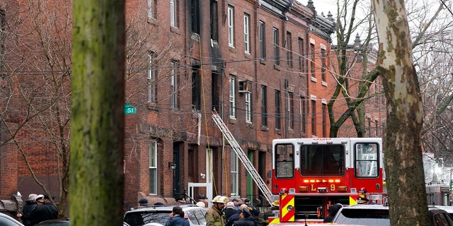 Firefighters work at the scene of a deadly rowhouse fire Wednesday in the Fairmount neighborhood of Philadelphia. 