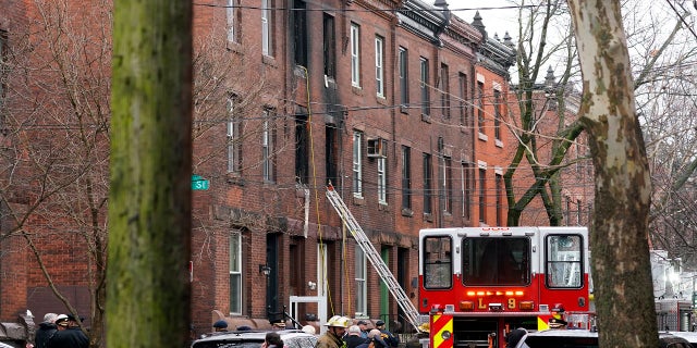 Philadelphia firefighters work at the scene of a deadly row house fire, on Wednesday in the Fairmount neighborhood of Philadelphia.