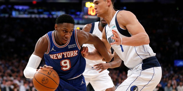 New York Knicks guard RJ Barrett (9) drives to the basket against Dallas Mavericks center Dwight Powell (7) during the second half of an NBA basketball game, Wednesday, Jan. 12, 2022, in New York.