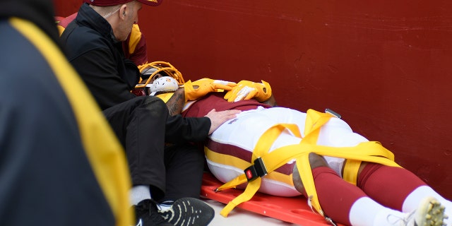 Ricky Seals-Jones is carted off the field in a stretcher after colliding with a cameraman while playing against the Philadelphia Eagles, Sunday, Jan. 2, 2022, in Landover, Maryland.