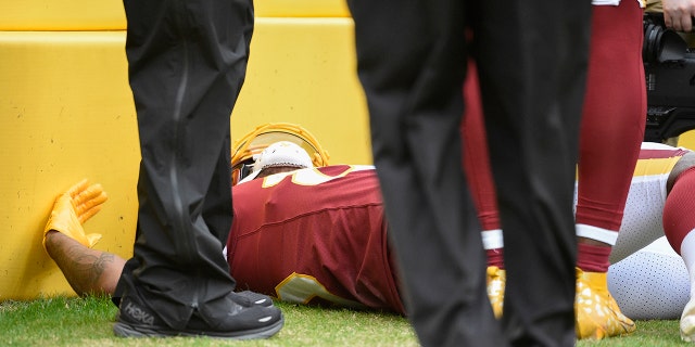 Washington Football Team tight end Ricky Seals-Jones lying on the sidelines after a collision with a cameraman during the Sunday, Jan. 2, 2022, game against the Philadelphia Eagles in Landover, Maryland.