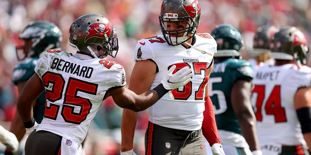 Giovani Bernard (25) of the Tampa Bay Buccaneers celebrates with Rob Gronkowski (87) after scoring a touchdown against the Philadelphia Eagles during the first quarter in the NFC Wild Card Playoff game at Raymond James Stadium on Jan. 16, 2022, in Tampa, Florida.