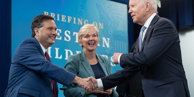 President Biden shakes hands with White House chief of staff Ron Klain alongside Secretary of Energy Jennifer Granholm as he arrives for a briefing on wildfires ahead of the wildfire season with cabinet members, government officials, as well as governors of several western states, in the Eisenhower Executive Office Building in Washington, June 30, 2021.