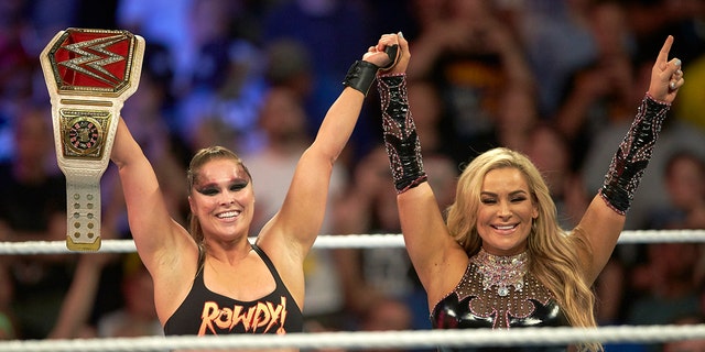 Professional Wrestling: WWE SummerSlam: Ronda Rousey victorious in ring with Charlotte Flair while holding belt after winning Raw Women's Championship match vs Alexa Bliss during event at Barclays Center.
Brooklyn, NY.