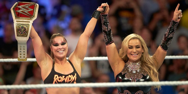 Professional Wrestling: WWE SummerSlam: Ronda Rousey victorious in ring with Charlotte Flair while holding belt after winning Raw Women's Championship match vs Alexa Bliss during event at Barclays Center.
Brooklyn, NY.