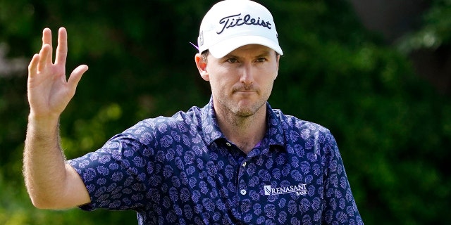 Russell Henley waves after making an eagle on the ninth hole during the second round of the Sony Open golf tournament, Friday, Jan. 14, 2022, at Waialae Country Club in Honolulu.