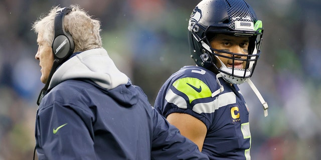 Head coach Pete Carroll and Russell Wilson (3) of the Seattle Seahawks interact on the sidelines during the second half against the Detroit Lions at Lumen Field Jan. 2, 2022, in Seattle.