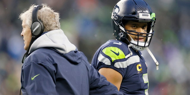 Head coach Pete Carroll and Russell Wilson of the Seattle Seahawks at Lumen Field on Jan. 2, 2022 in Seattle, Washington.