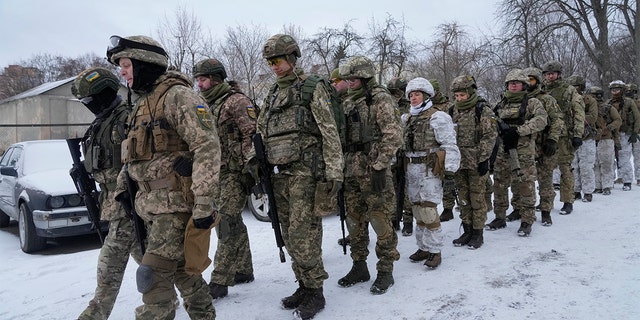 Members of Ukraine's Territorial Defense Forces, volunteer military units of the Armed Forces, train in a city park in Kyiv, Ukraine, Saturday, Jan. 22, 2022.