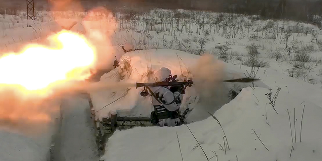 In this photo taken from video provided by the Russian Defense Ministry Press Service on Tuesday, a Russian paratrooper attends a military exercise at the Pesochnoe training ground in the Yaroslavl region.