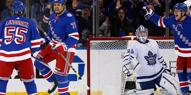 New York Rangers' Ryan Reaves (75) celebrates his goal on Toronto Maples Leafs goalie Jack Campbell with Ryan Lindgren (55) during the first period of an NHL hockey game Wednesday, Jan. 19, 2022, in New York.
