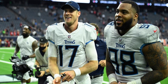 Tennessee Titans quarterback Ryan Tannehill (17) and defensive end Jeffery Simmons (98) celebrate their win over the Houston Texans Sunday, Jan. 9, 2022, in Houston.