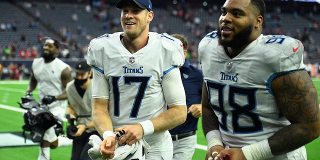 Tennessee Titans quarterback Ryan Tannehill (17) and defensive end Jeffery Simmons (98) celebrate their win over the Houston Texans Sunday, Jan. 9, 2022, in Houston.