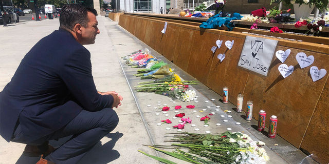 San Jose Mayor Sam Liccardo stops to view a makeshift memorial for the rail yard shooting victims in front of City Hall in San Jose, Calif., on May 27, 2021.