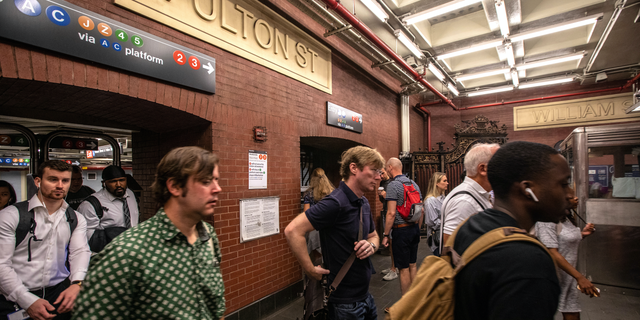 Commuters are seen inside Manhattan's Fulton Street subway station.