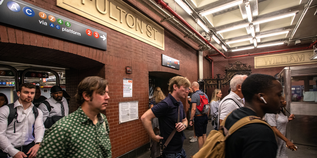 Commuters are seen inside Manhattan's Fulton Street subway station.