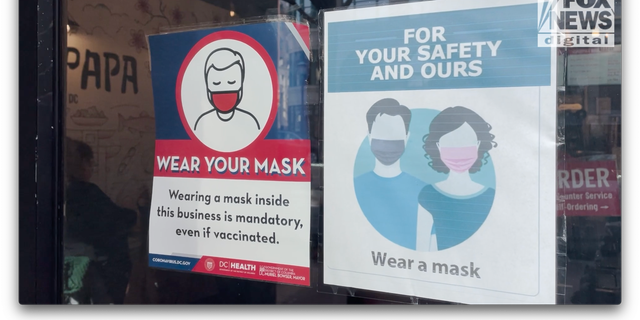 Mask signs hanging at a restaurant in downtown Washington, D.C.