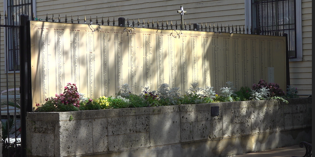 Hundreds of homicide victims are listed on a wall outside St. Anna's Episcopal Church in New Orleans.