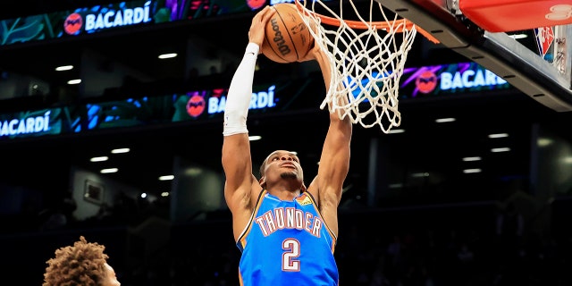 Oklahoma City Thunder guard Shai Gilgeous-Alexander (2) goes up for a dunk against the Brooklyn Nets during the first half of an NBA basketball game, Thursday, Jan. 13, 2022, in New York.