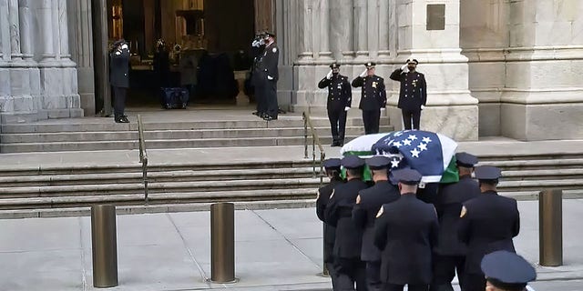A casket carrying the body of NYPD Officer Jason Rivera body arrives at Saint Patrick .