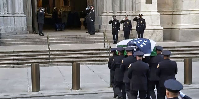 A casket carrying the body of NYPD Officer Jason Rivera body arrives at Saint Patrick .