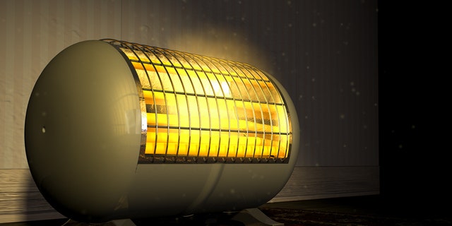 A cylindrical-shaped electric space heater is shown illuminated and radiating in one room of a house. Make sure your family follows the important safety guidelines outlined in this article before using a space heater in your home. 