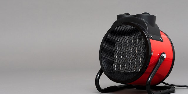 Electric heater on a gray background with copy space.