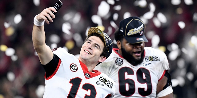 Georgia Bulldogs quarterback Stetson Bennett takes a selfie as confetti flies at the conclusion of the College Football Playoff National Championship at Lucas Oil Stadium in Indianapolis on Jan. 10, 2022.