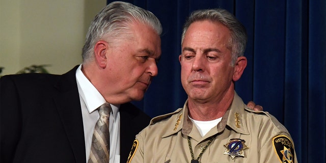 FILE - Clark County Commission Chairman Steve Sisolak (L) talks to Clark County Sheriff Joe Lombardo during a news conference on the mass shooting at a country music festival on Oct. 4, 2017, in Las Vegas. 