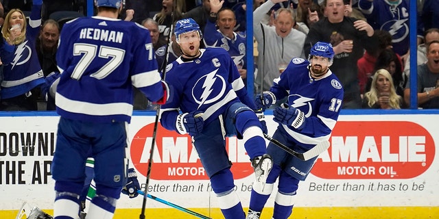 Tampa Bay Lightning center Steven Stamkos (91) celebrates his goal against the Vancouver Canucks with defenseman Victor Hedman (77) and left wing Alex Killorn (17) during the first period of an NHL hockey game Thursday, Jan. 13, 2022, in Tampa, Fla.